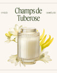 Candle labeled 'Champs de Tuberose' with tuberose flowers on a white background