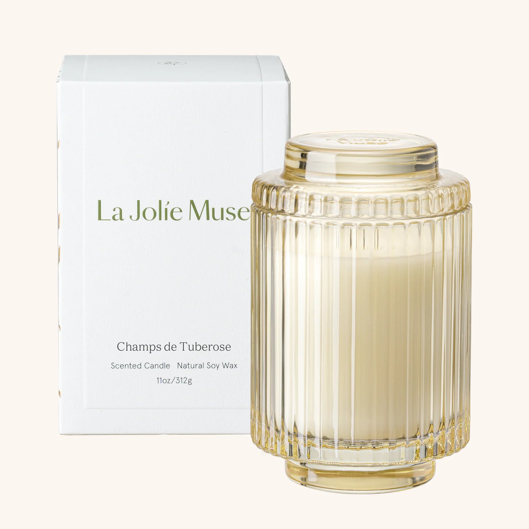 La Jolie Muse scented candle with ribbed glass design and matching box on a white background