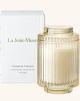La Jolie Muse scented candle with ribbed glass design and matching box on a white background
