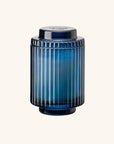Blue glass jar with ribbed design on a white background