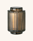 Decorative cylindrical lantern with ribbed design on a white background