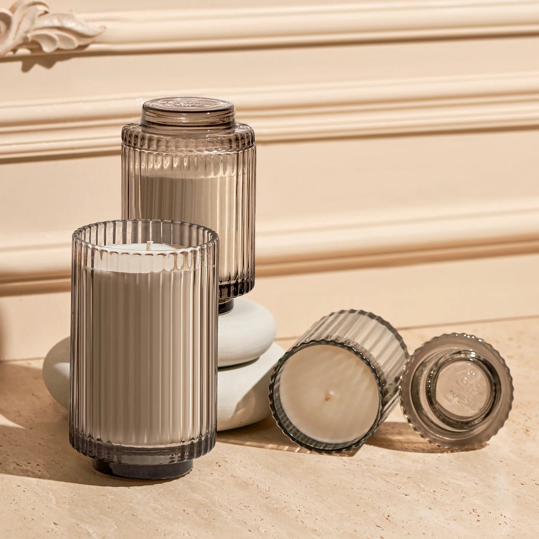 Set of Island Coconut 11oz Candles in glass holders on a textured surface