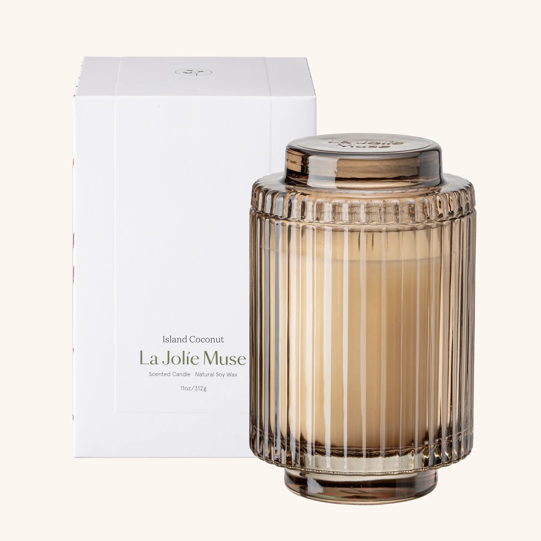 La Jolie Muse candle with ribbed glass design and white box on a white background