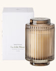 La Jolie Muse candle with ribbed glass design and white box on a white background