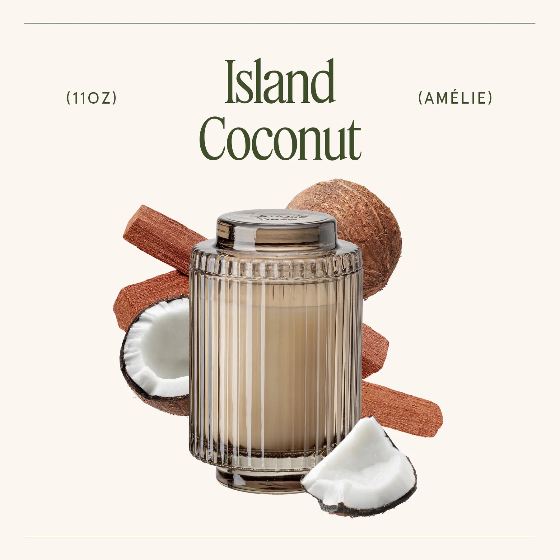 Candle labeled 'Island Coconut' with coconuts and cinnamon sticks on a white background