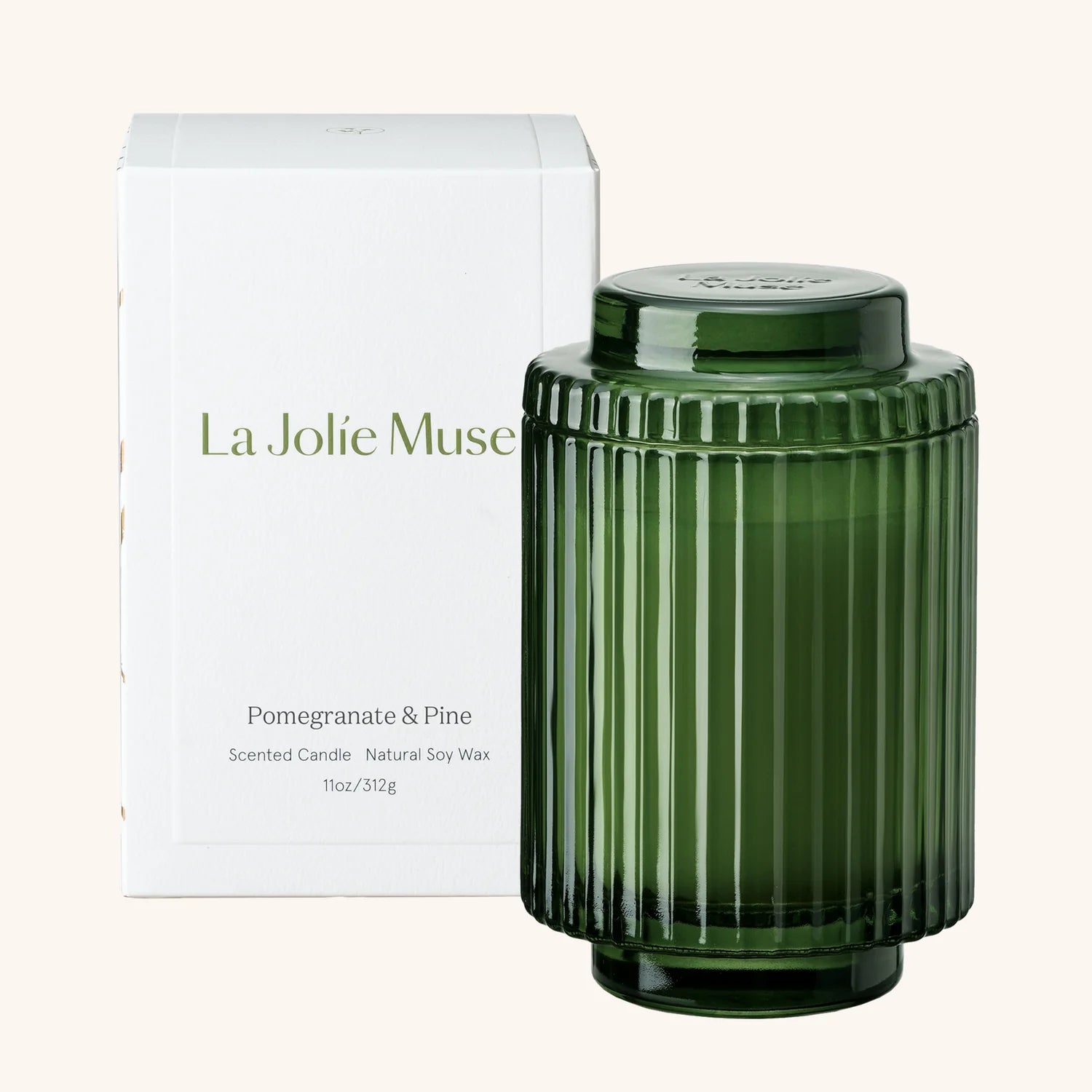 Green ribbed candle with lid and 'La Jolie Muse' packaging on a white background