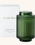 Green ribbed candle with lid and 'La Jolie Muse' packaging on a white background