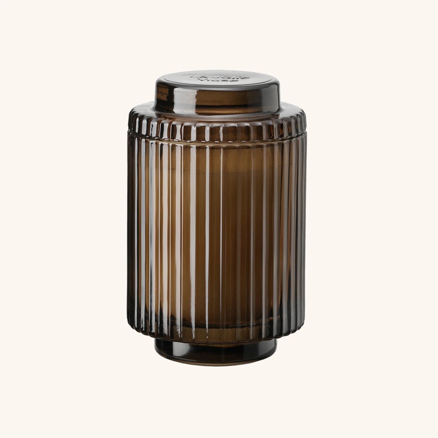 Brown ribbed glass jar with a lid on a white background