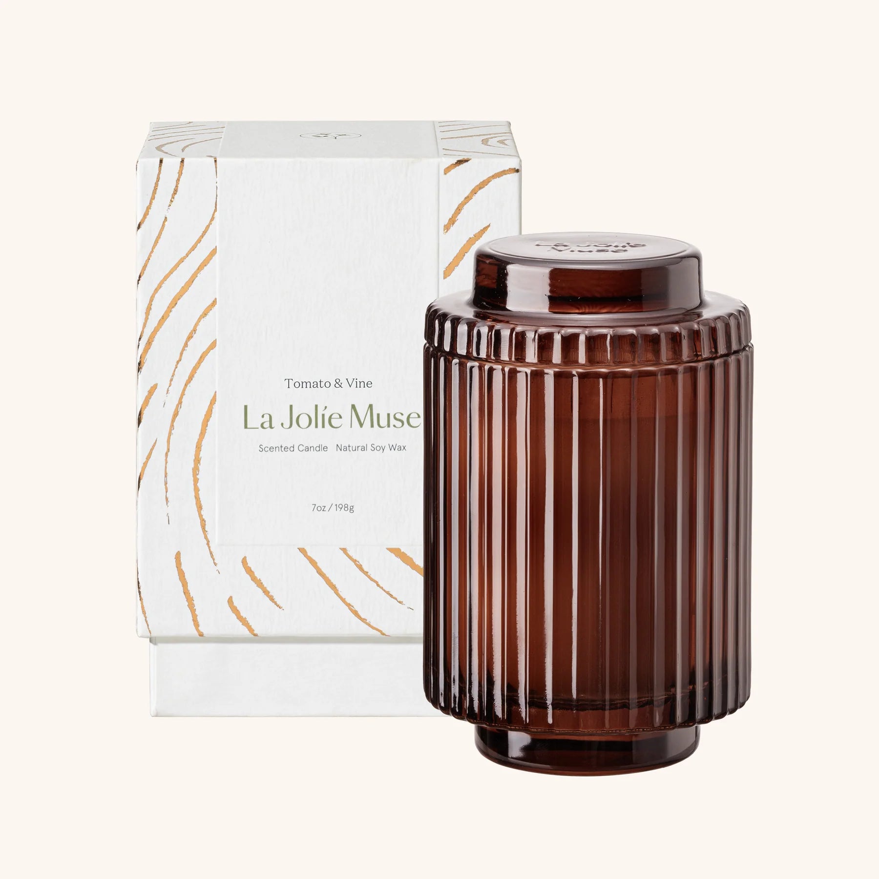 Brown ribbed candle with lid and 'La Jolie Muse' packaging on a white background
