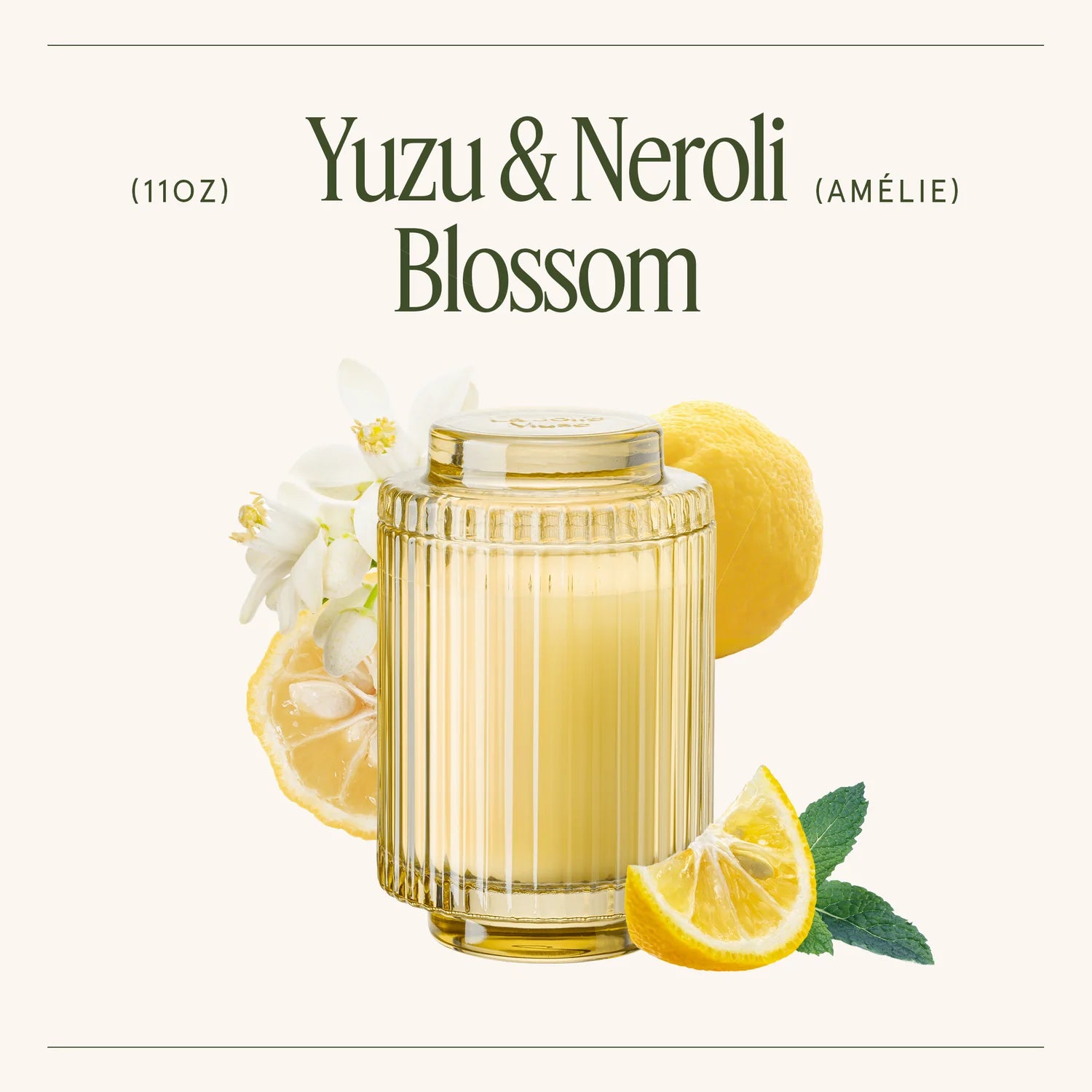 Glass of yuzu & neroli blossom drink with lemon slices and flowers on a white background