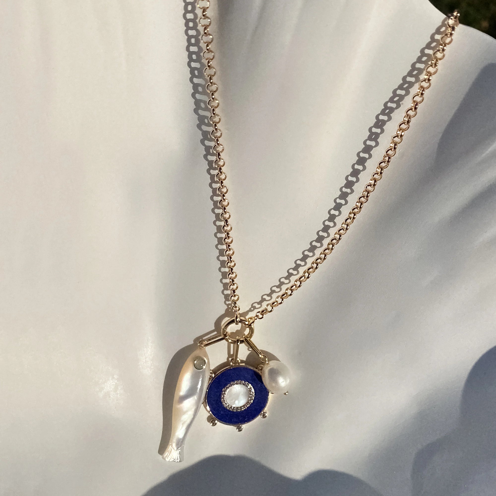 Vienna Charm Necklace with three charms attached to it