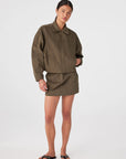 Eames Mini Skirt full body front with zipped up jacket