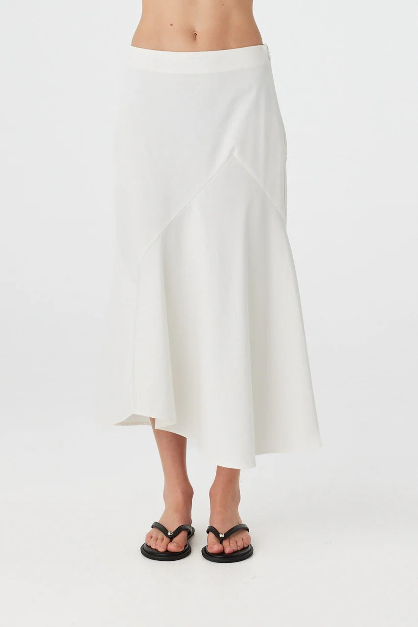 White skirt worn by a person on a white background