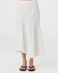 White skirt worn by a person on a white background