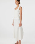 Woman wearing a white dress on a white background