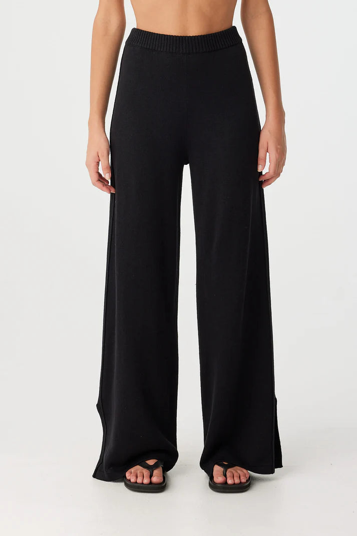 Black wide-leg pants worn by a person on a white background, front