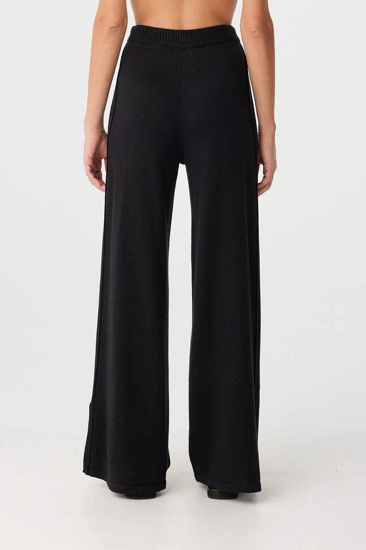 Black wide-leg pants worn by a person on a white background, back