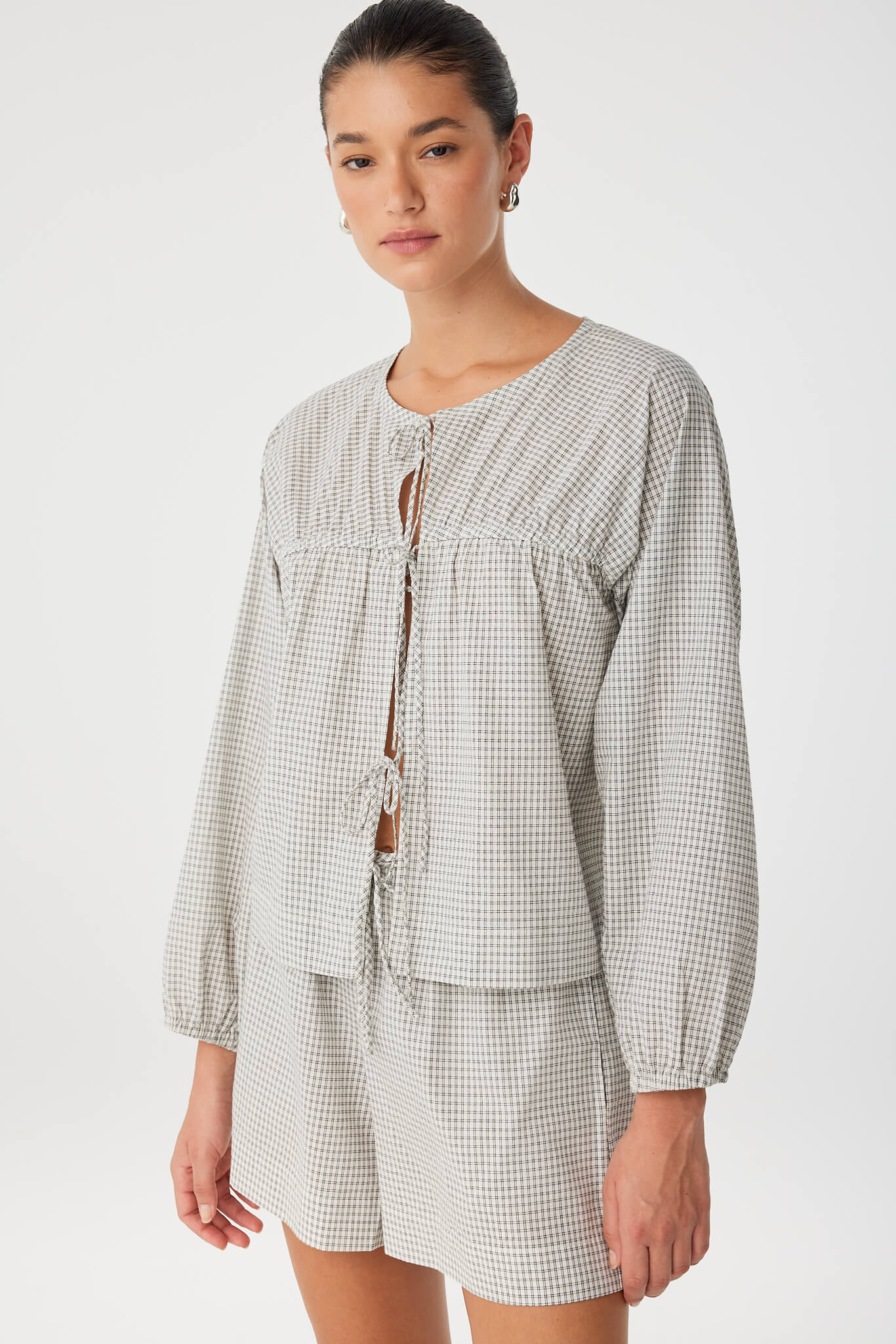 Woman wearing a checkered outfit on a white background