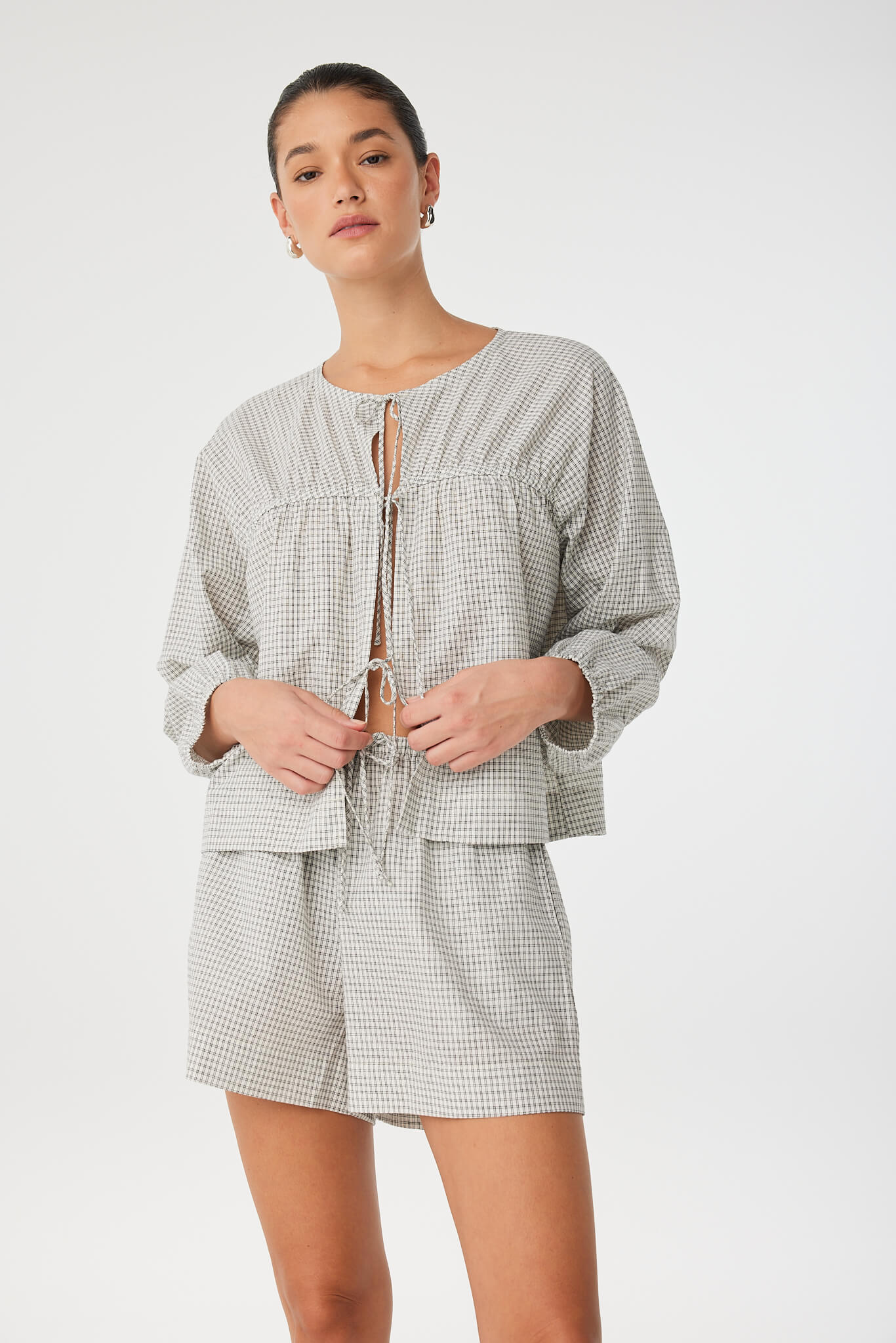 Woman wearing a checkered outfit on a white background