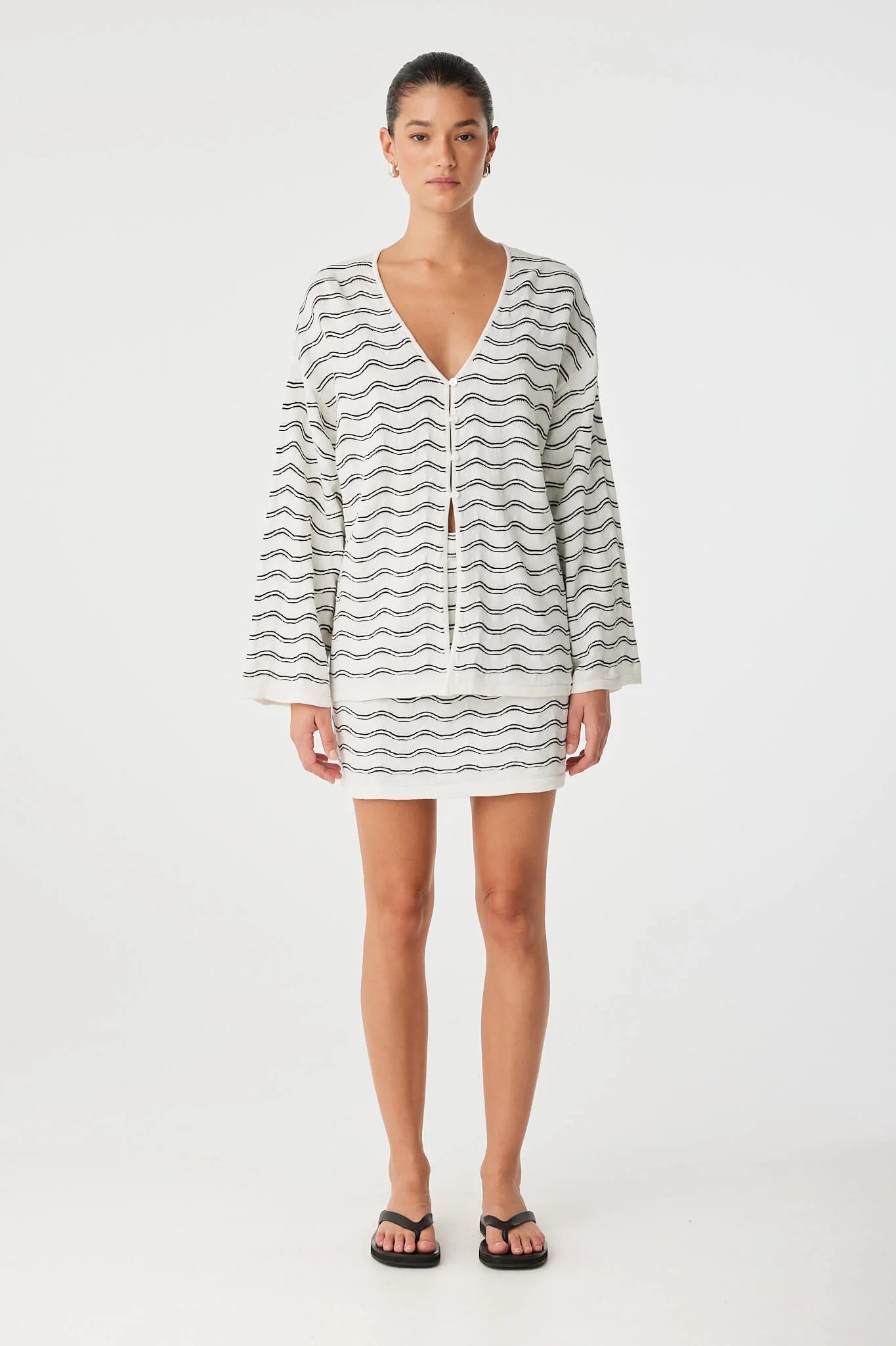 Woman wearing a striped dress on a white background