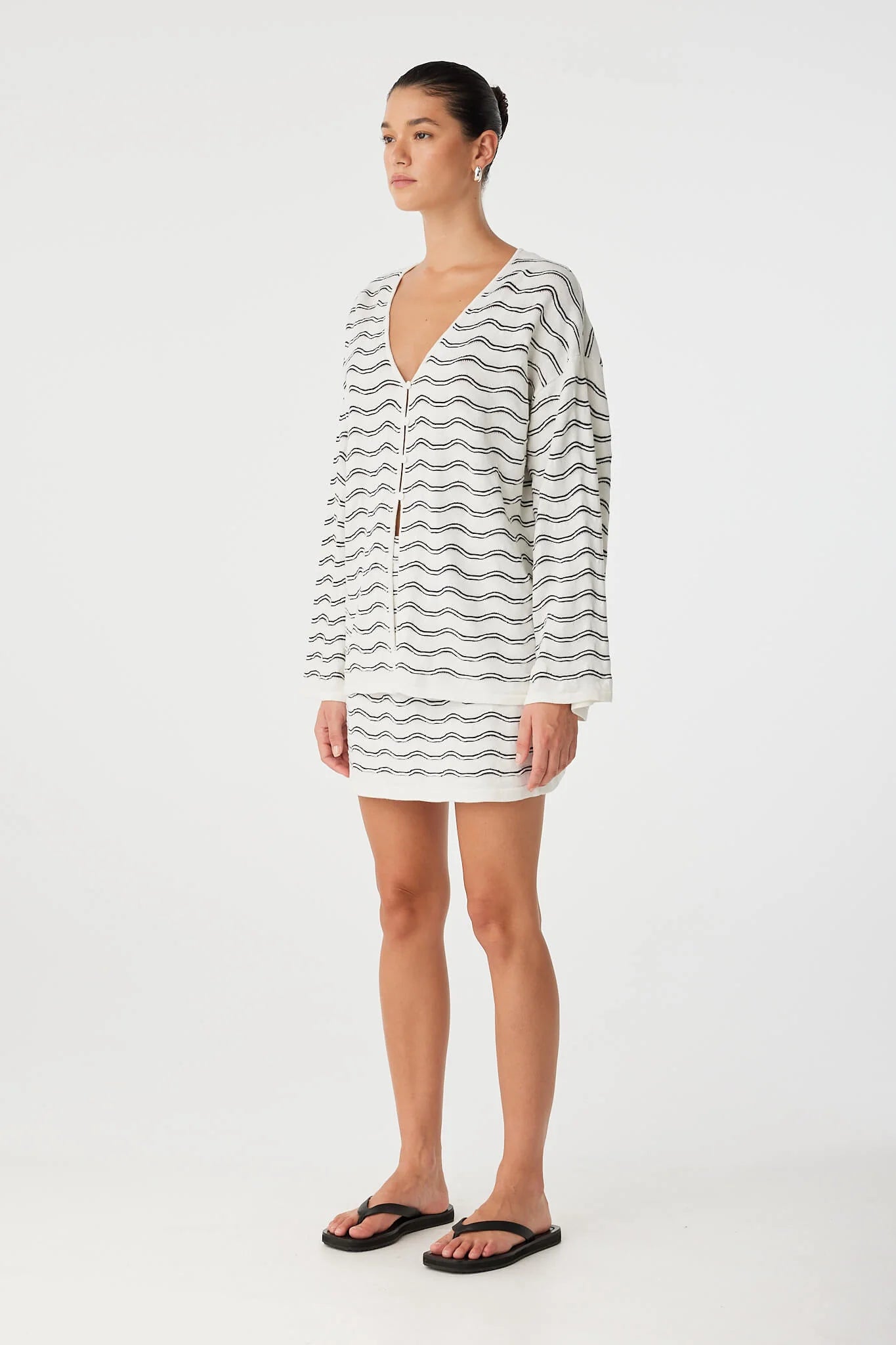 Woman wearing a striped dress on a white background