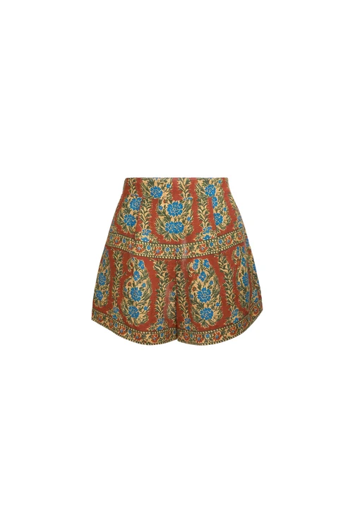 A pair of high-waisted, tiered shorts featuring an intricate paisley and floral pattern in rust red, blue, green, and gold, set against a plain white background.