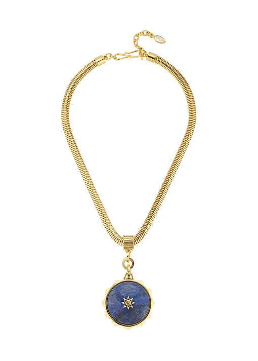 A gold-toned snake chain necklace featuring a circular pendant with a deep blue lapis lazuli-style center and a small gold star motif, displayed on a clean white background.