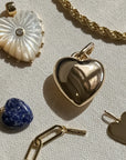 Collection of heart-shaped pendants on a textured surface