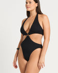 model wearing a black cut out one piece on white background