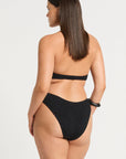 model wearing a black cut out one piece on white background