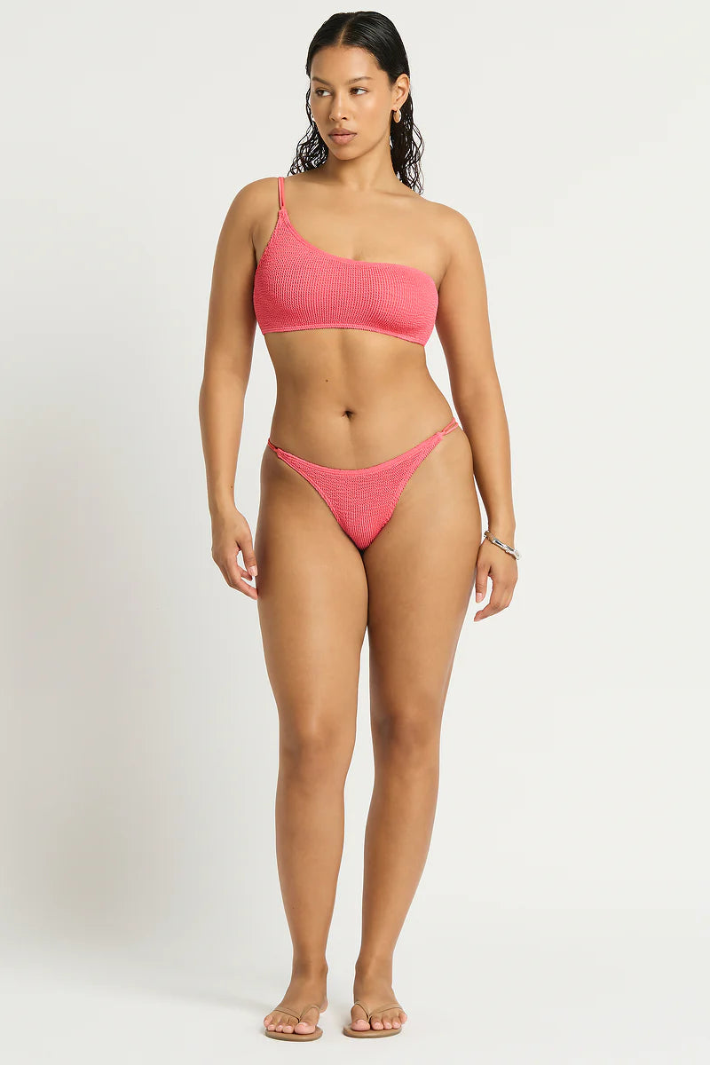 Model size M wearing Lotus Brief in Coral Pink and Lotus Crop in Coral Pink, front