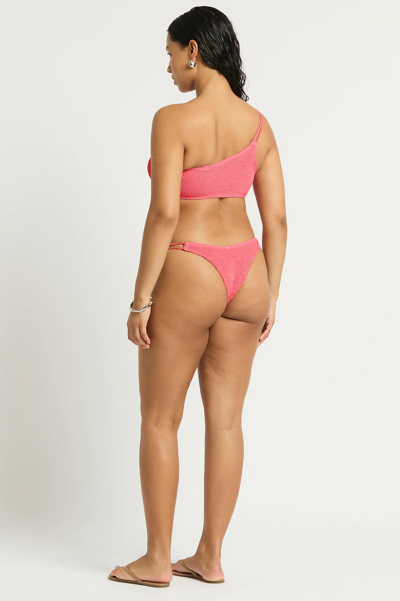 Model size M wearing Lotus Brief in Coral Pink and Lotus Crop in Coral Pink, back