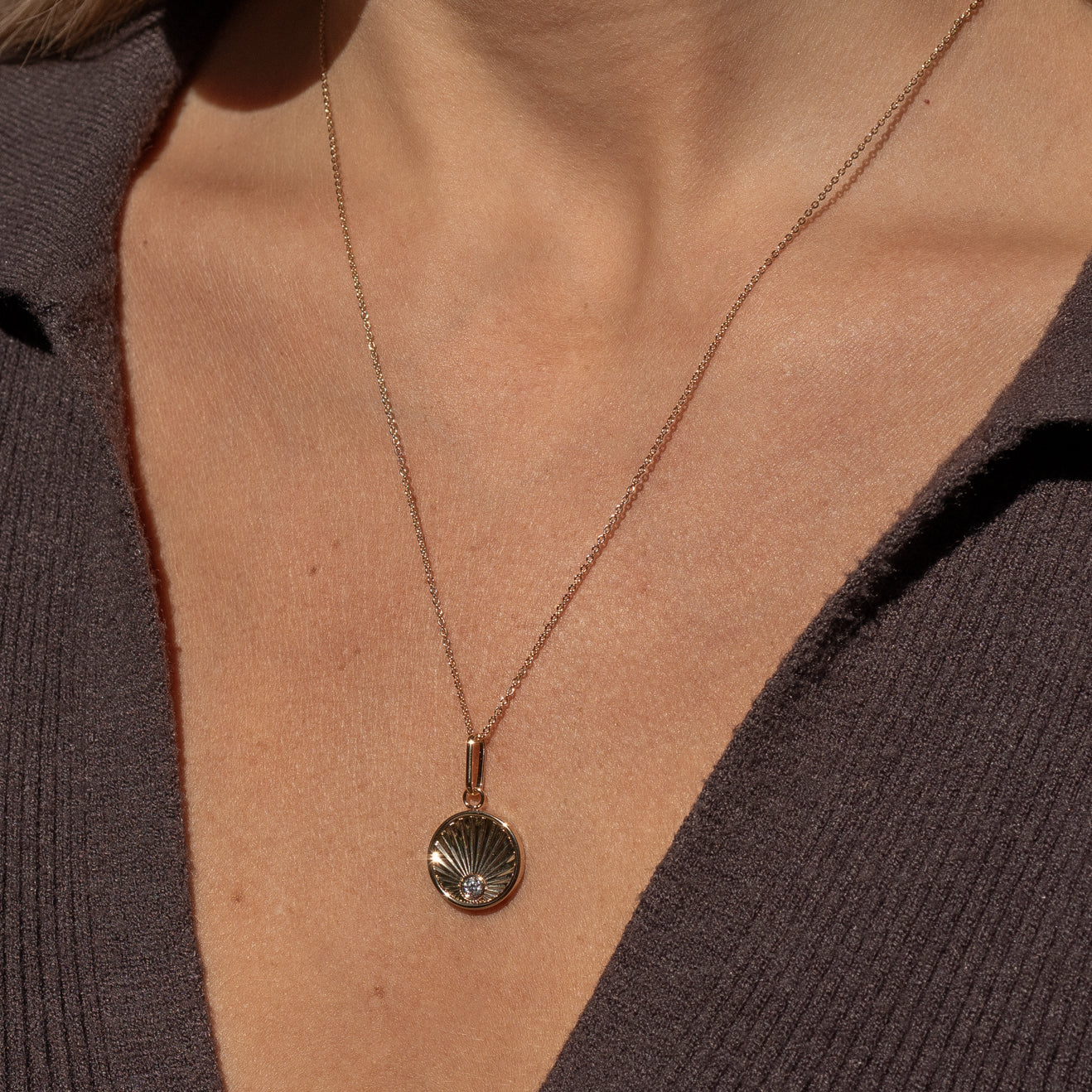 Birth of Venus Charm front view attached to small chain necklace on model
