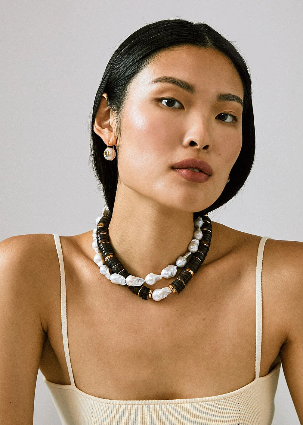 Bilbao II Collar Necklace layered with freshwater pearl necklace