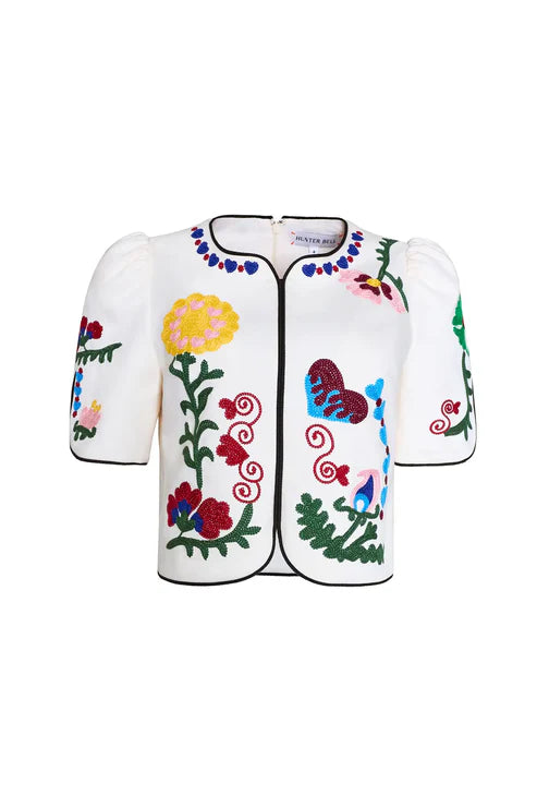 White shirt with colorful floral embroidery on a white background