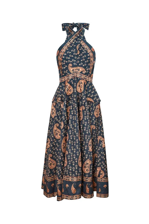 A halter-neck maxi dress with a black base and a detailed paisley and floral block print in rust orange and cream, shown against a plain white background.