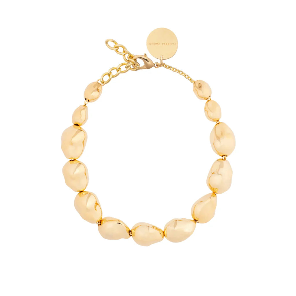 Gold beaded bracelet on a white background