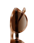 Close-up of a pair of sunglasses with a translucent brown acetate frame and dark brown lenses, shown against a solid white background.