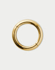 Gold circular bangle bracelet on a white background