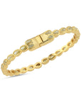 Gold bracelet with gemstones on a white background