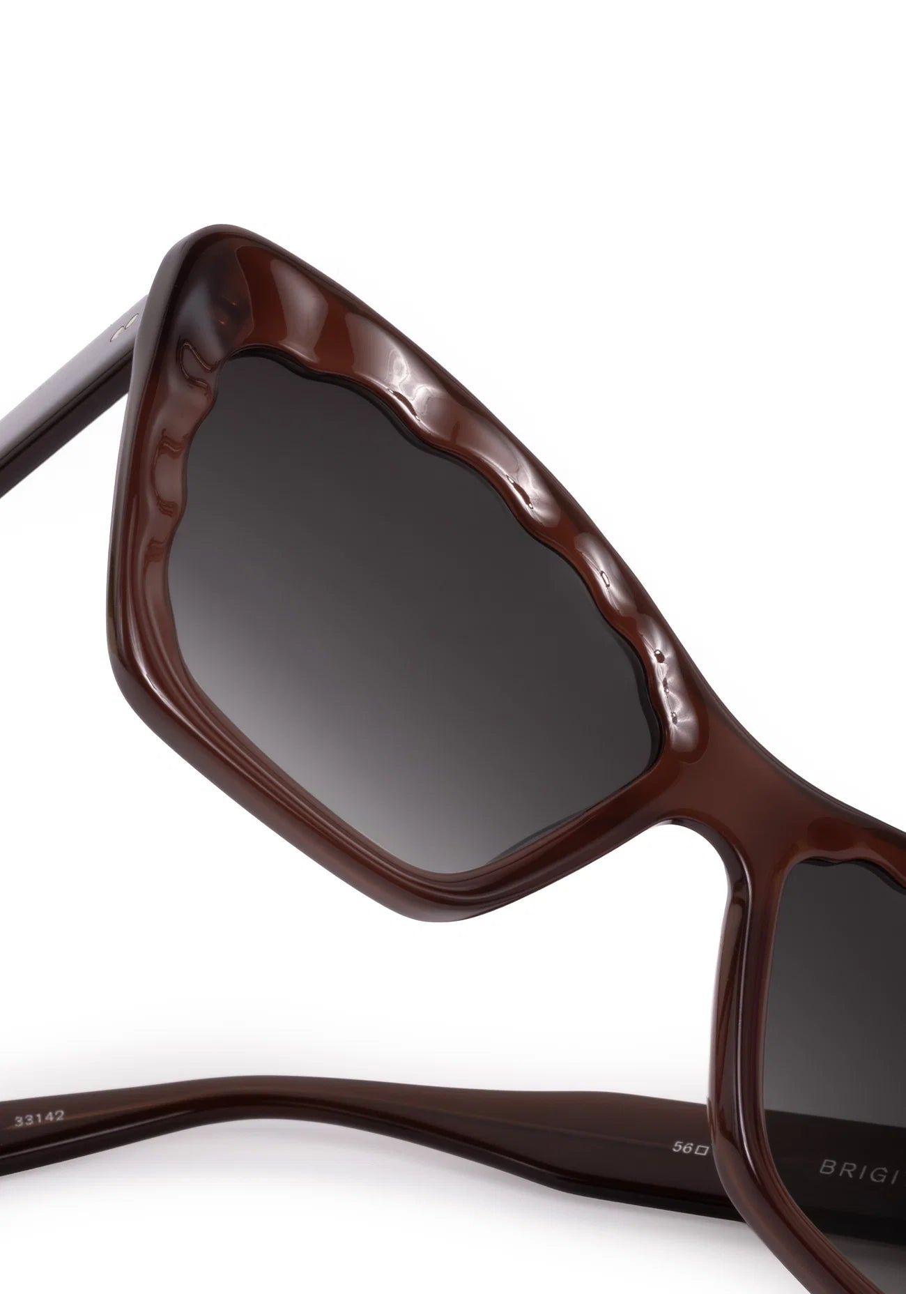Brown sunglasses with dark lenses on a white background