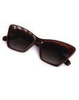 Brown sunglasses with dark lenses on a white background