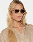 Brigette Gelato Sunglasses on model with average oval face shape, wearing tan top
