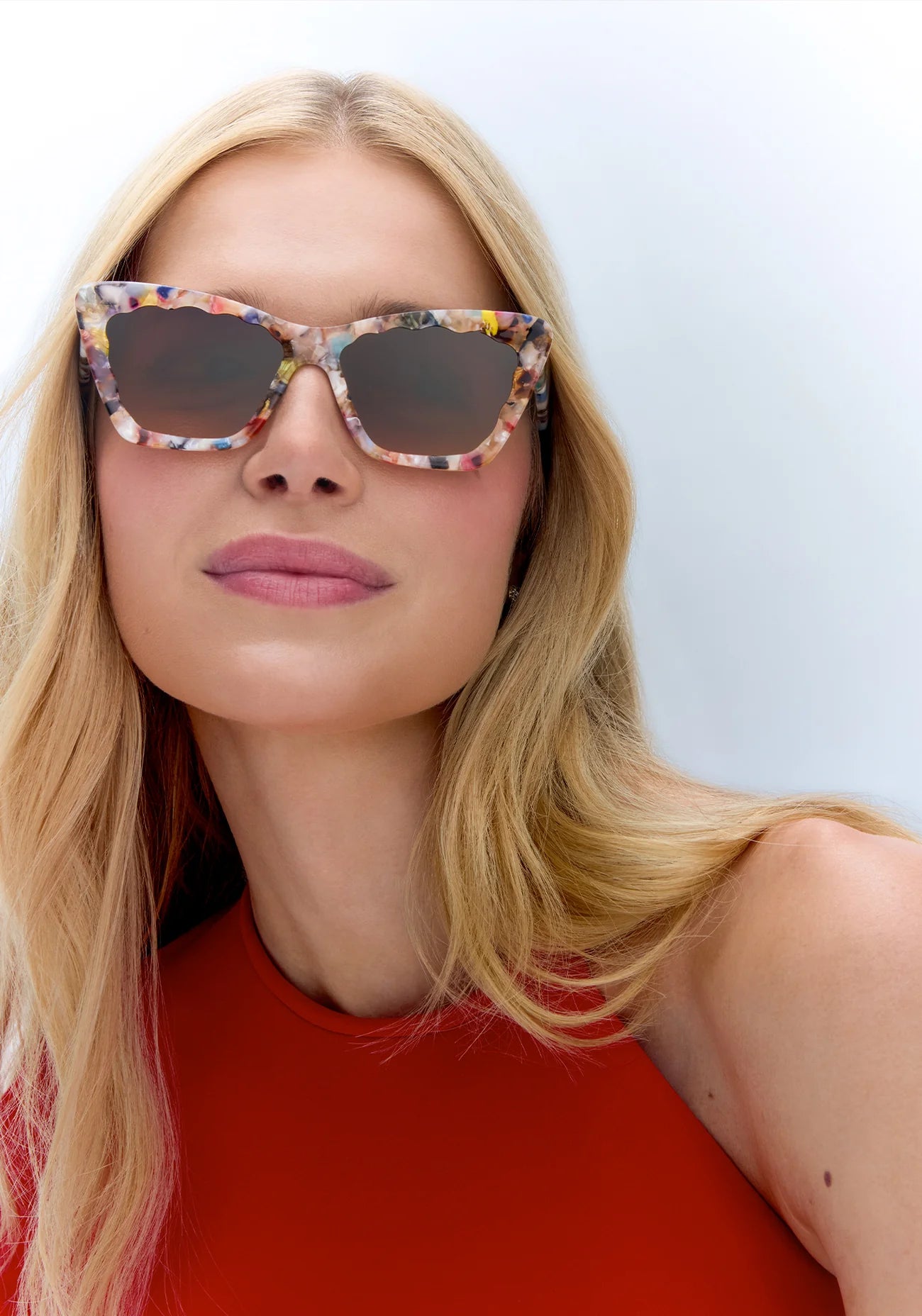 Brigette Gelato Sunglasses on model with average oval shape face in red shirt