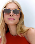 Brigette Gelato Sunglasses on model with average oval shape face in red shirt