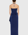 model wearing a dark blue ruffled dress on a white background, back view