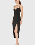 Woman wearing a black dress with a slit on a white background