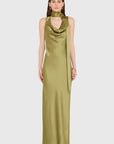 A model wearing a sleeveless, floor-length olive green satin gown with a draped cowl neckline and a matching tie at the waist, set against a solid light gray background.