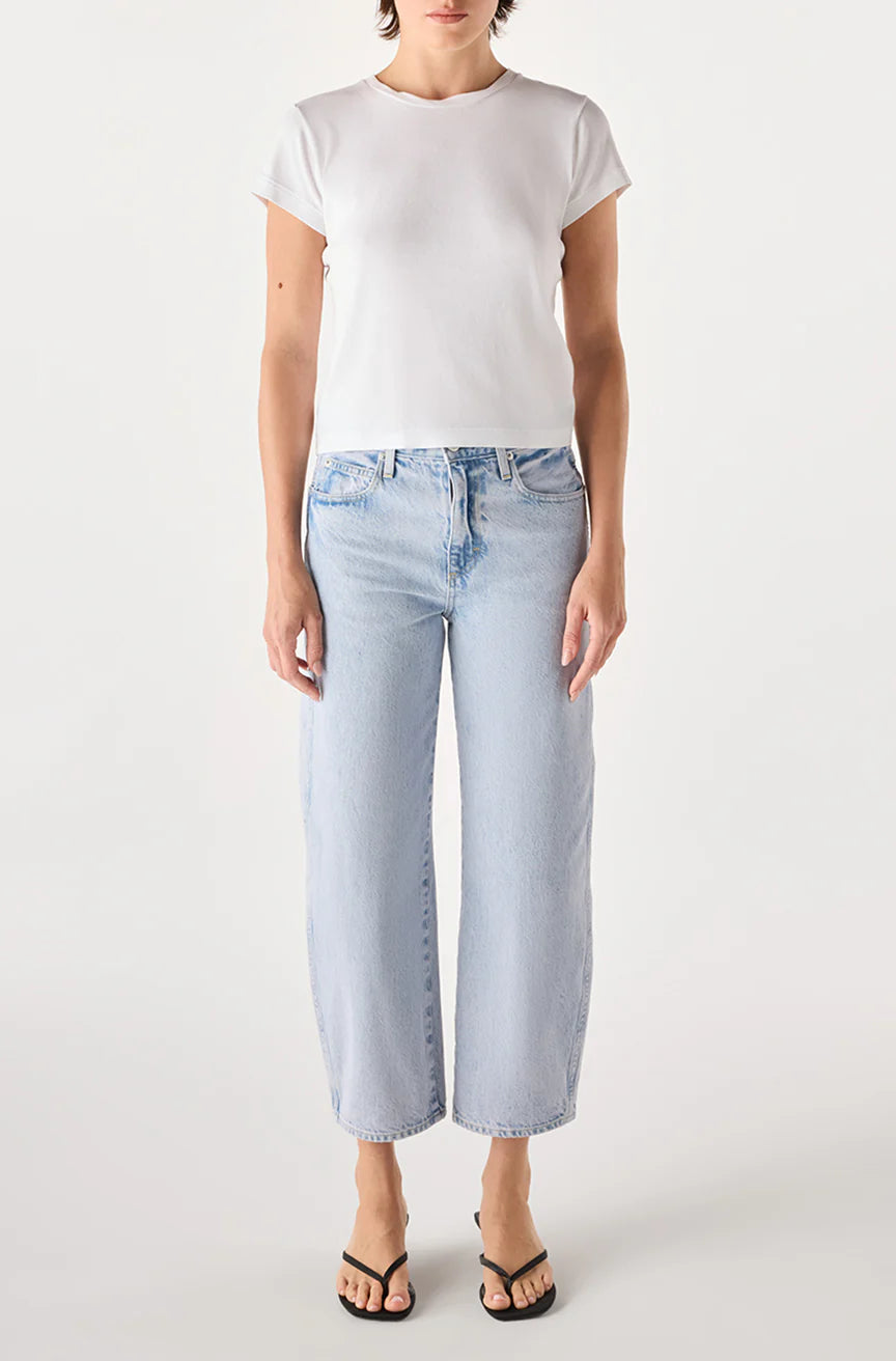 Person wearing a white t-shirt and light blue jeans on a white background