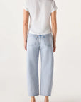 Person wearing a white top and light blue jeans on a white background